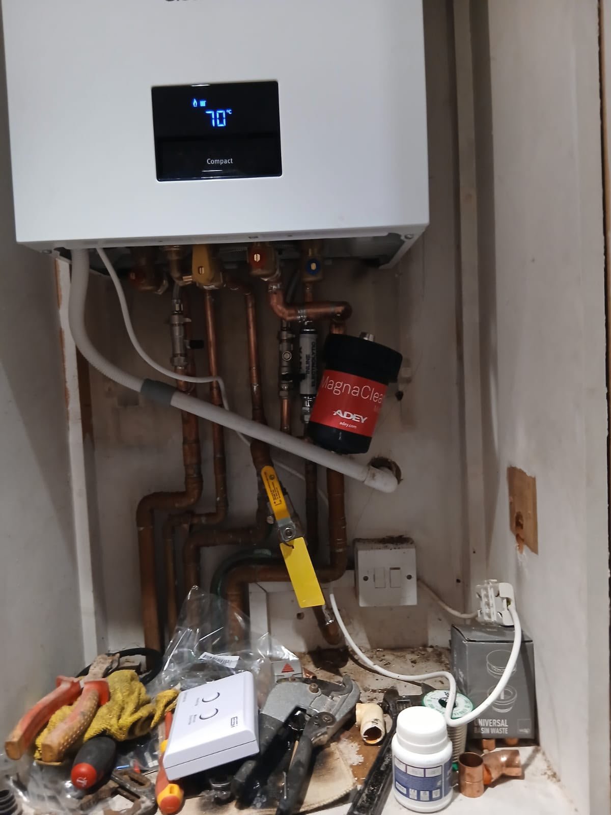 Modern condensing boiler installation with copper pipes and MagnaClean filter, showcasing KOZ Plumbing & Heating's