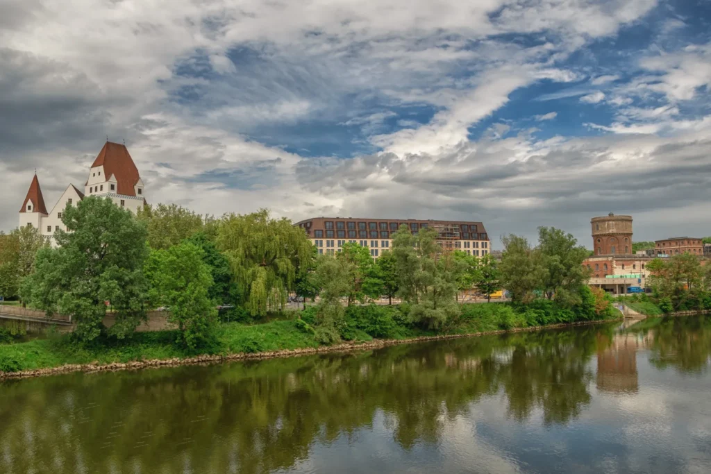 A bright, blue sky with fluffy white clouds above a tranquil river scene, suggesting reliable