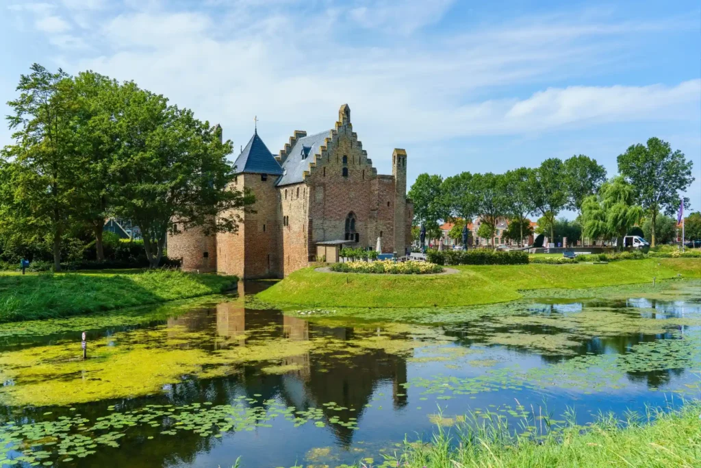 Historic castle reflected in a pond, symbolizing the reliable and established service of KOZ Plumbing