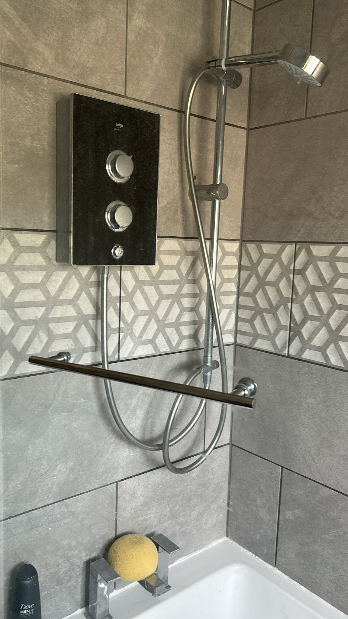 Newly installed electric shower with controls and handheld showerhead, showcasing KOZ Plumbing & Heating's expertise