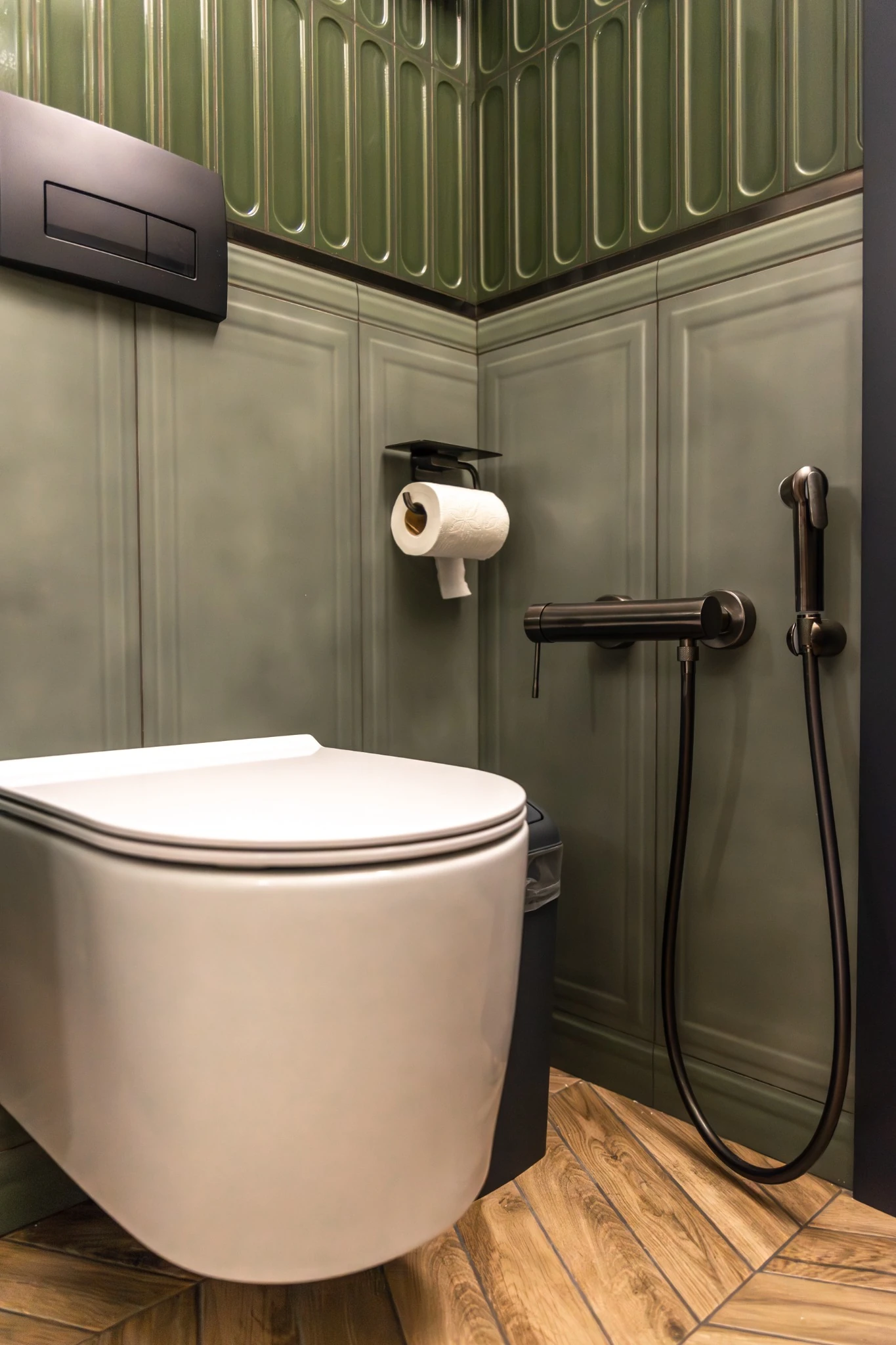 Stylish restroom featuring a wall-hung toilet with matte black fixtures, showcasing modern plumbing solutions offered